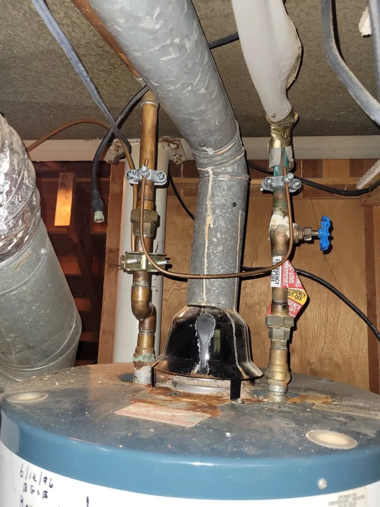 Corroded supply connections on top of a 31-year-old gas water heater