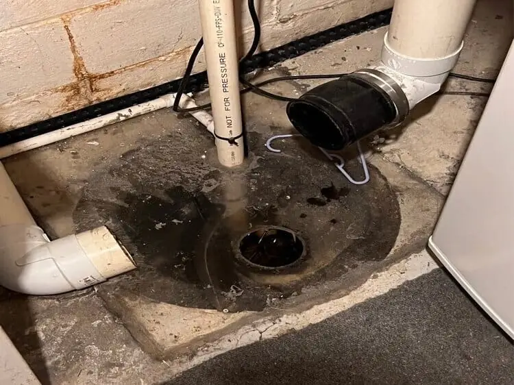 Sump pump pit and discharge lines in a Maryland basement